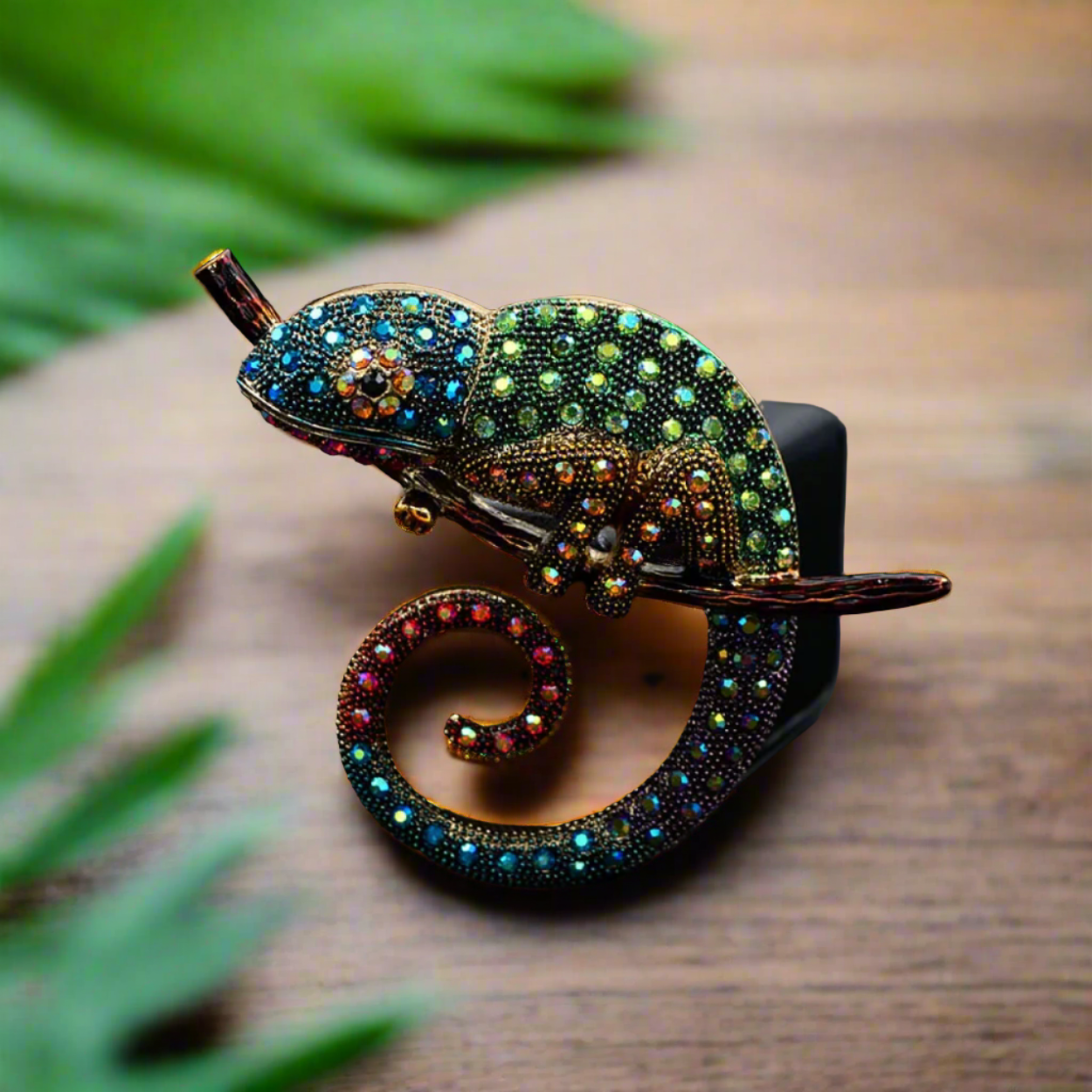 Vibrant chameleon lapel pin showcasing colorful gemstones from a side view.