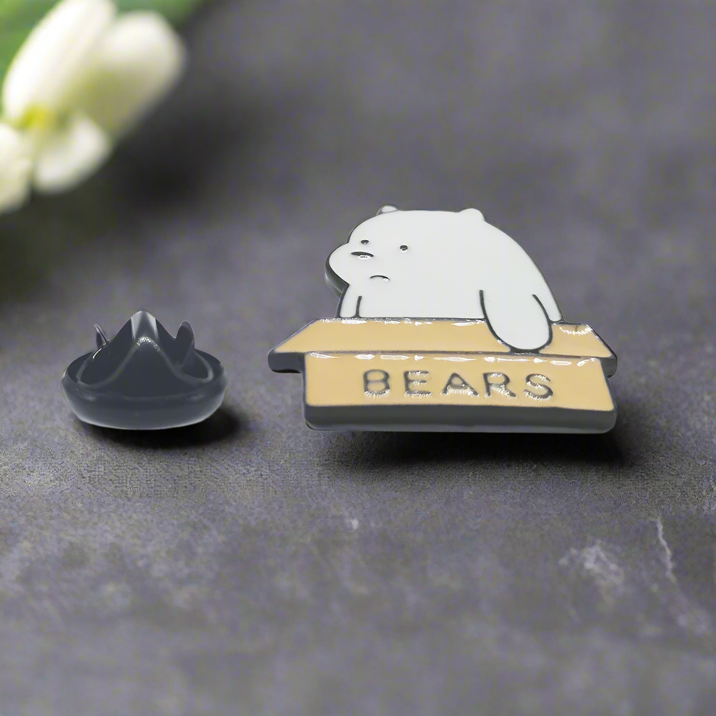 Close-up of the Charming Bear-in-a-Box Lapel Pin highlighting intricate details.
