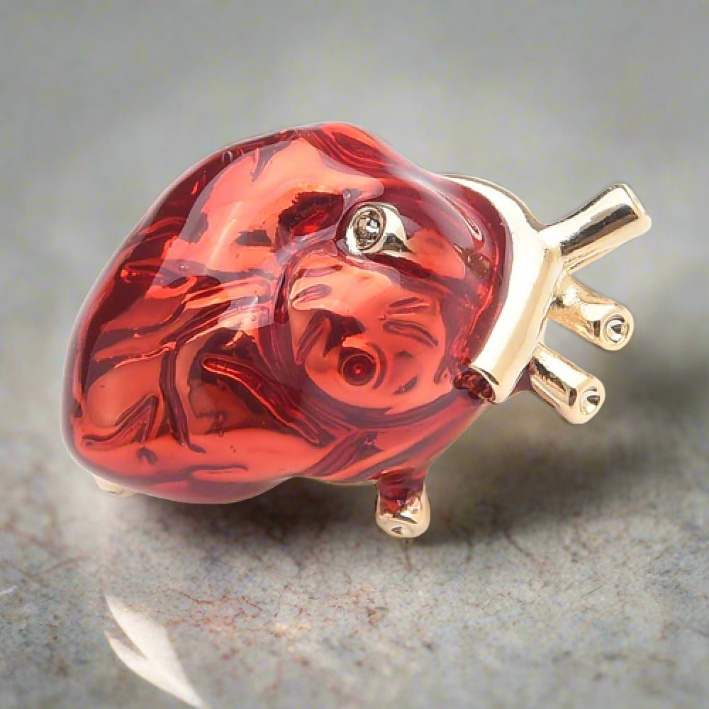 Heart lapel pin on a white dress shirt, showcasing its vibrant colors and unique design.
