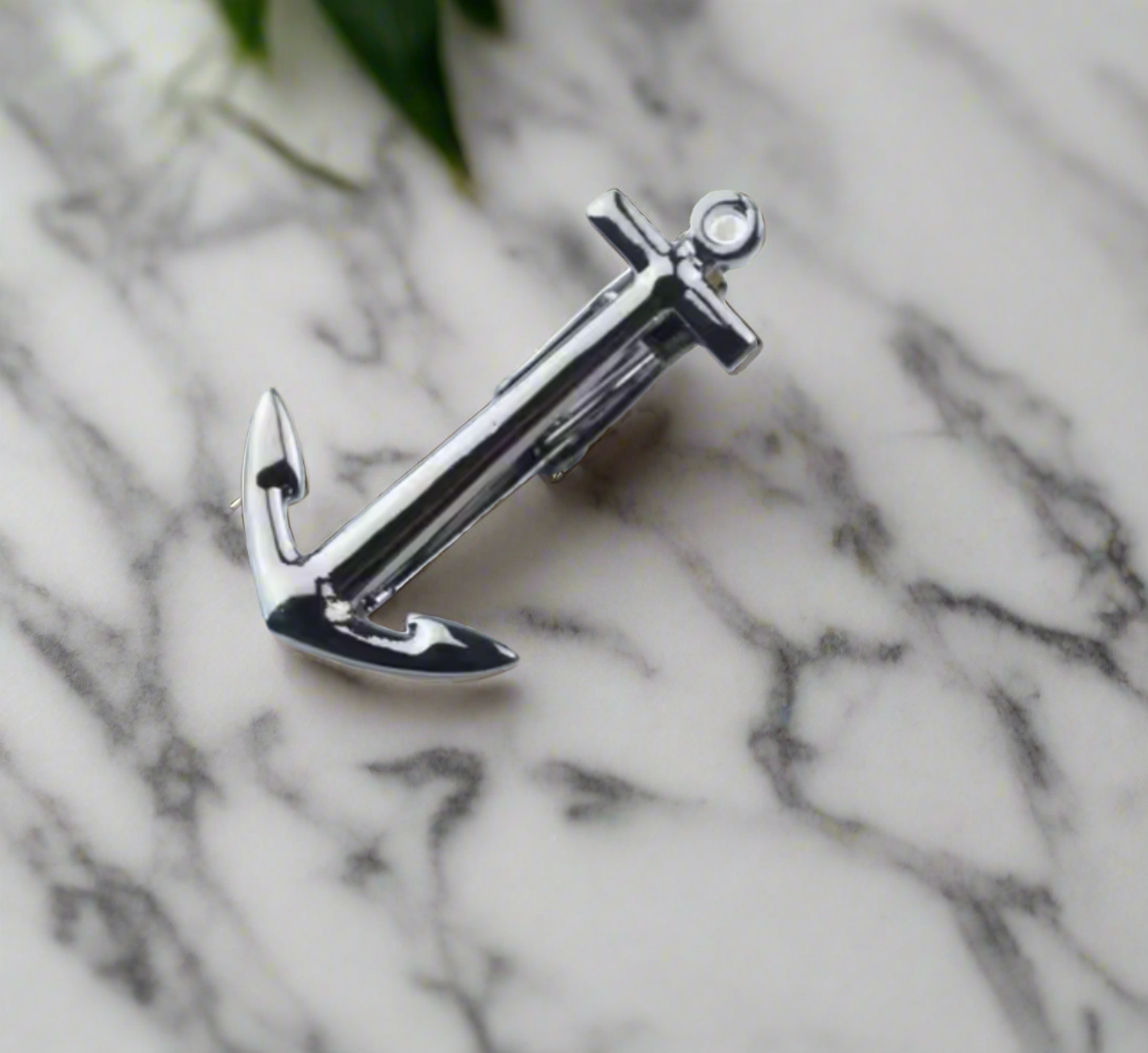 Mens tie clip in gold finish clipped onto a stylish suit for wedding attire