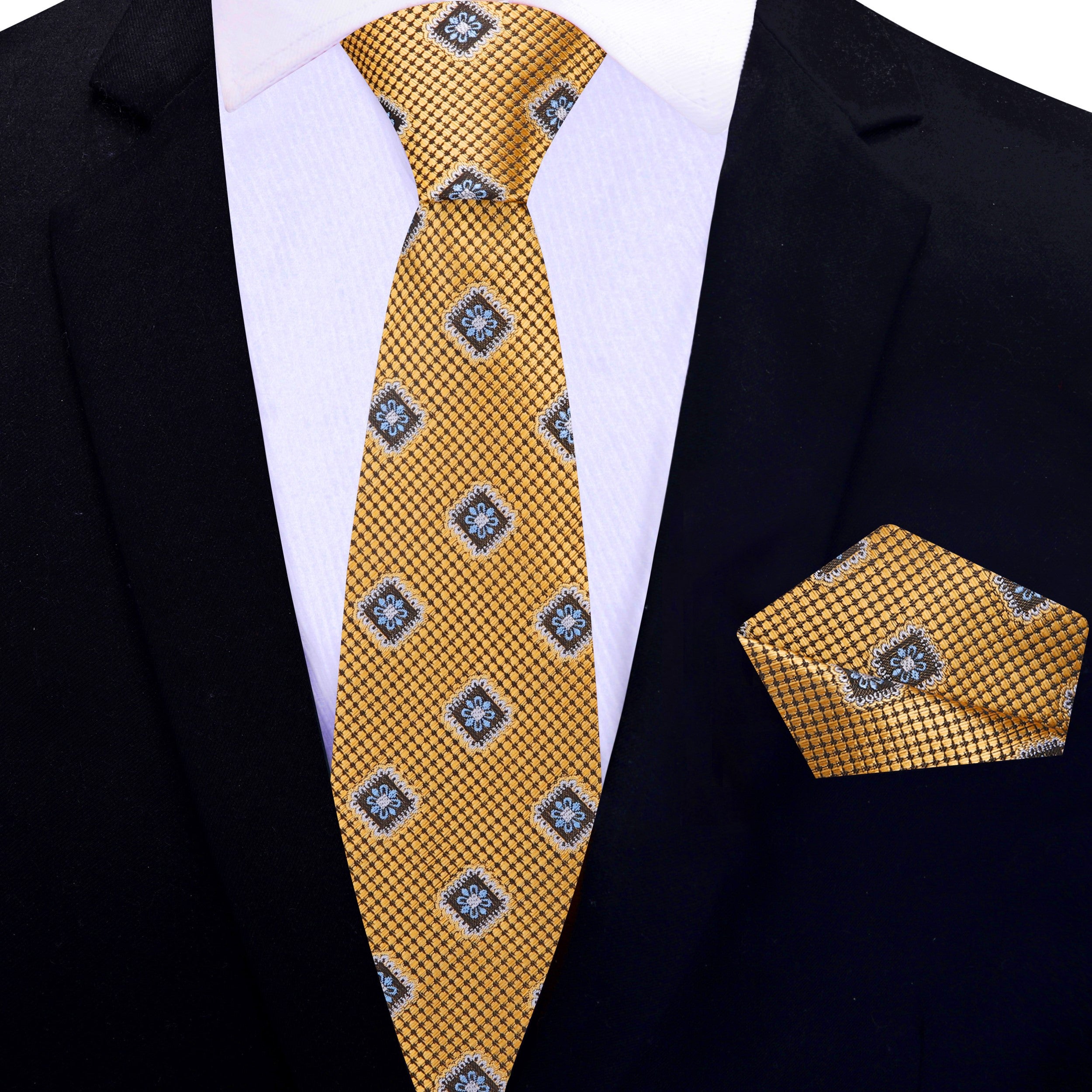 Stylish display of the gold necktie paired with a classic white dress shirt and navy suit.