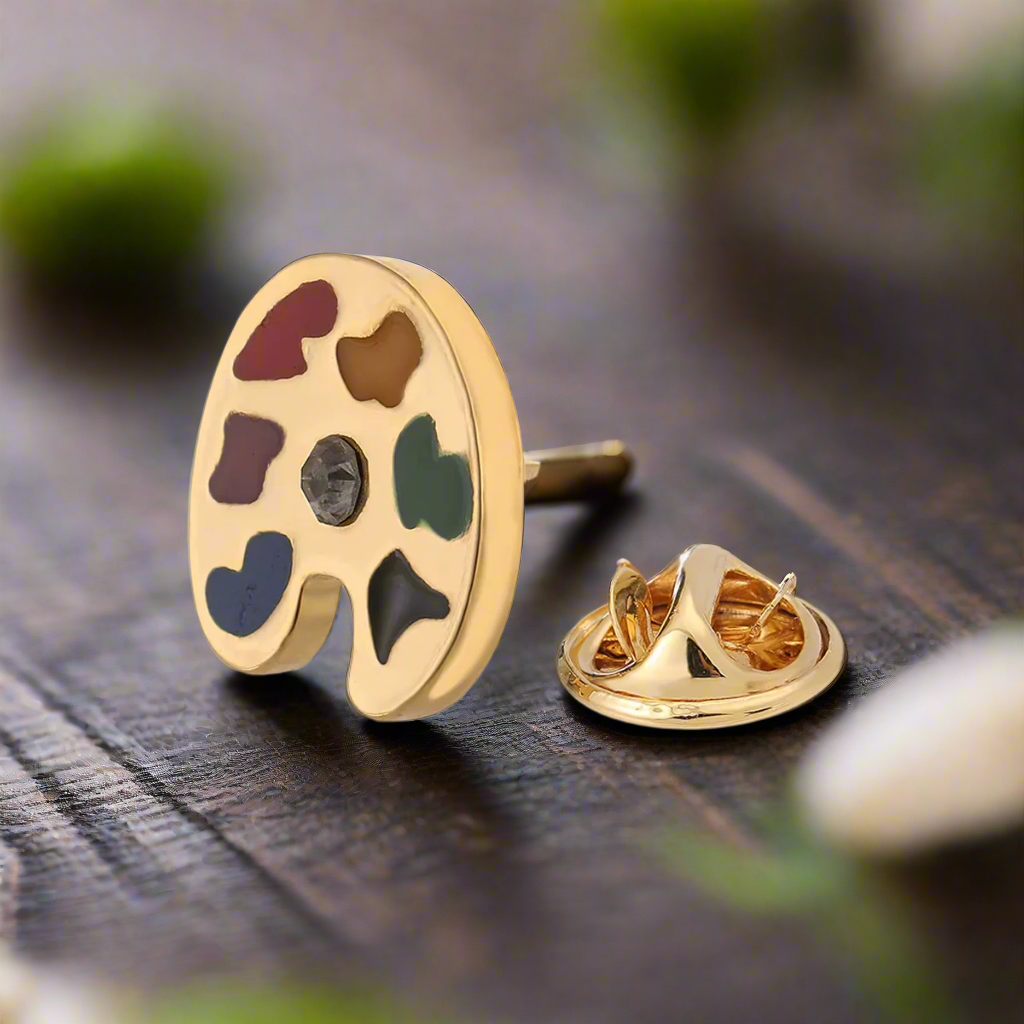 Artist palette lapel pin worn at an art gallery opening, adding creative flair to outfit