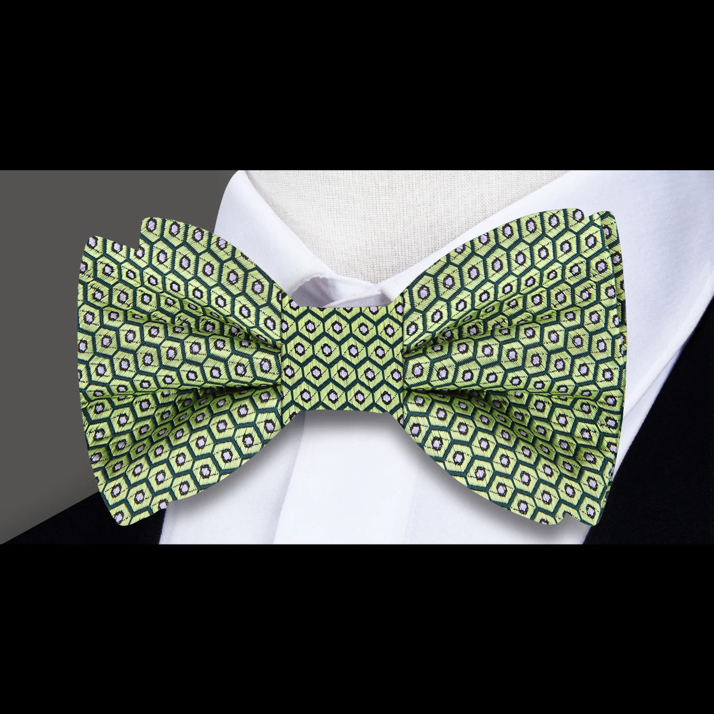 Chic geometric avocado bow tie displayed on a formal shirt, showcasing its unique pattern.