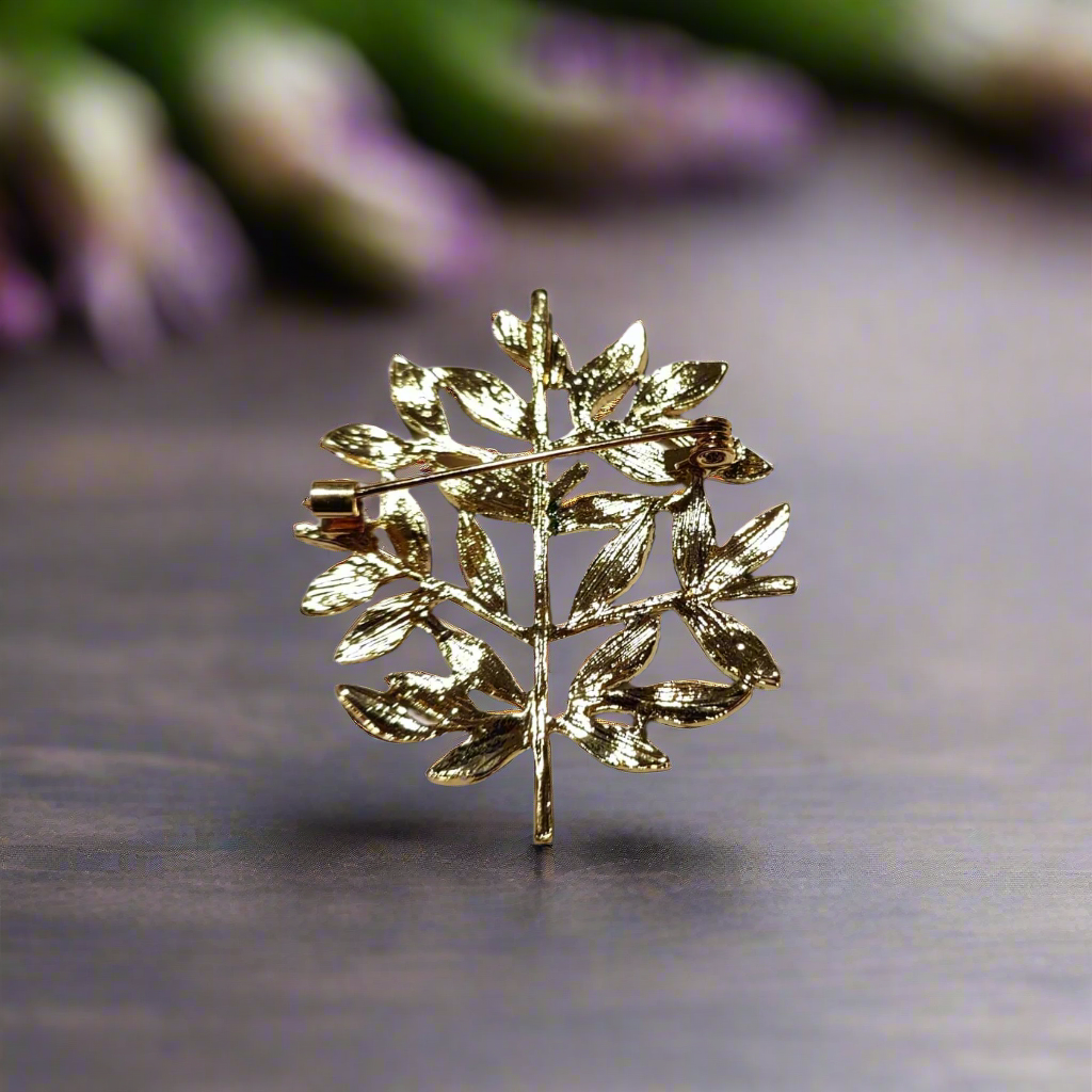 Man wearing olive leaves lapel pin on a wedding day outfit