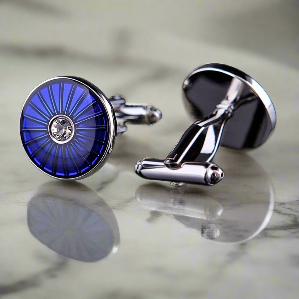 Stylish chrome cufflinks with blue gemstones on a dress shirt