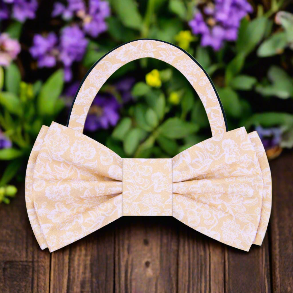 Light beige silk bow tie styled with a crisp dress shirt for upscale events