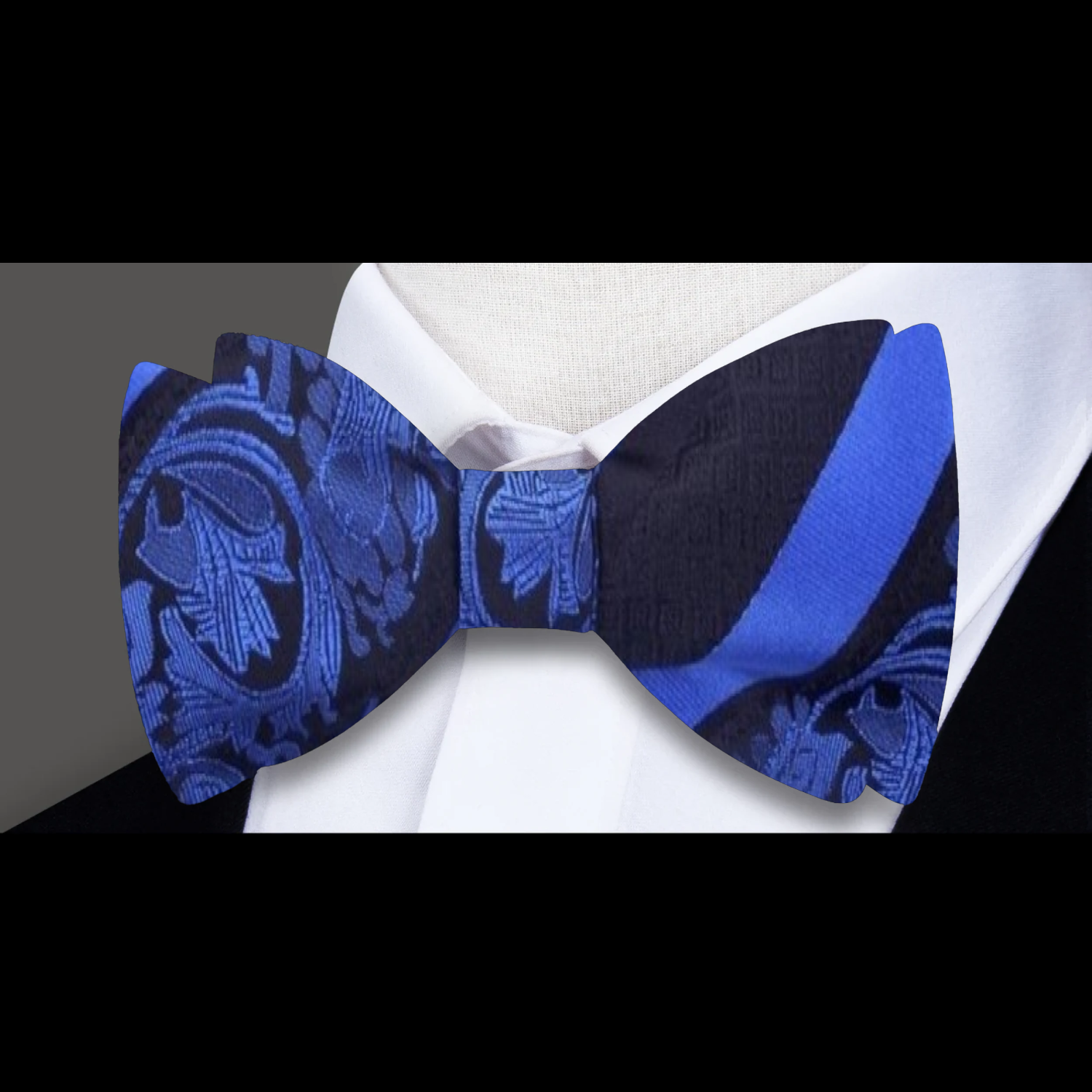 Close-up of black floral bow tie with red accents for formal wear