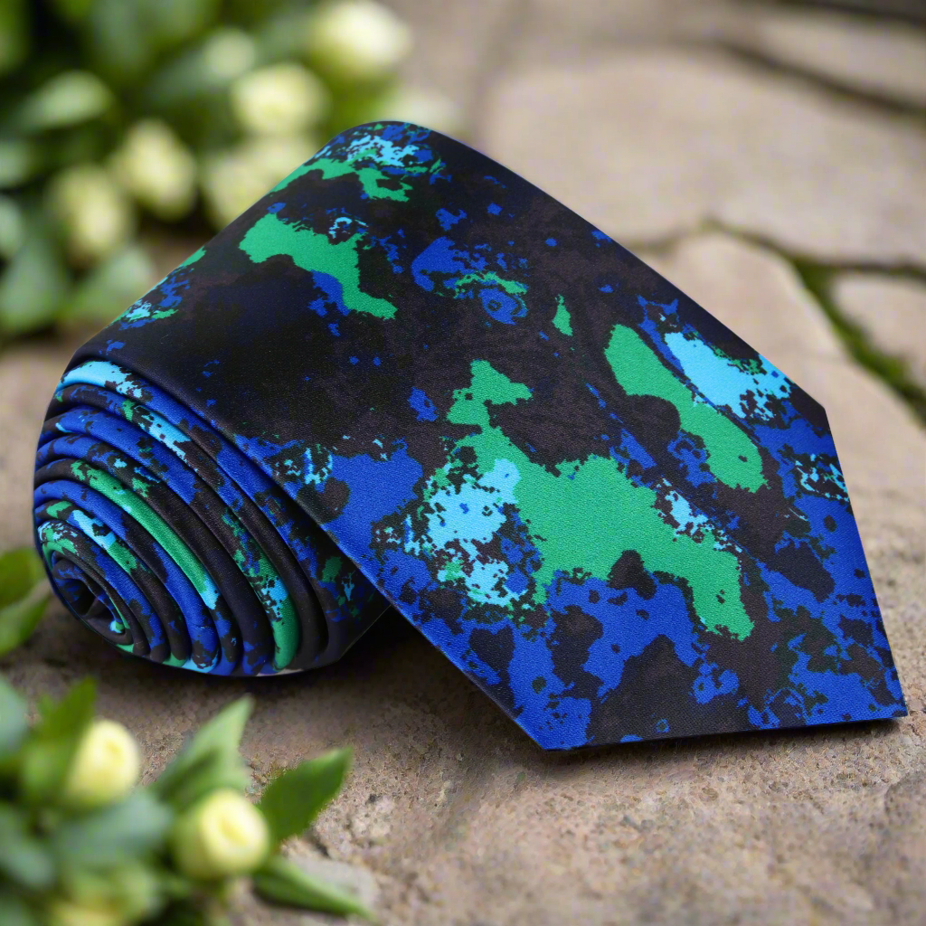 Close-up of the abstract ink blot silk necktie showing detailed pattern and vibrant colors