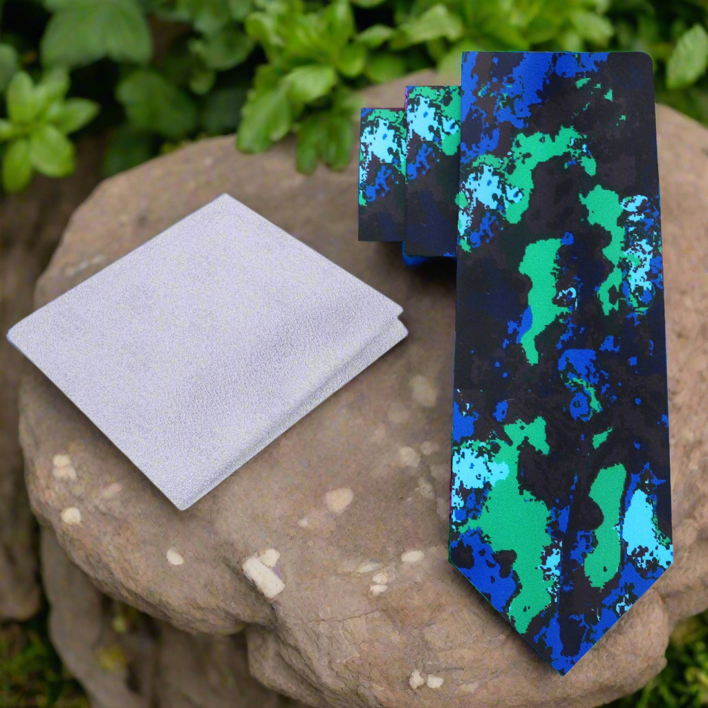 Close-up of the abstract ink blot silk necktie showing detailed pattern and vibrant colors