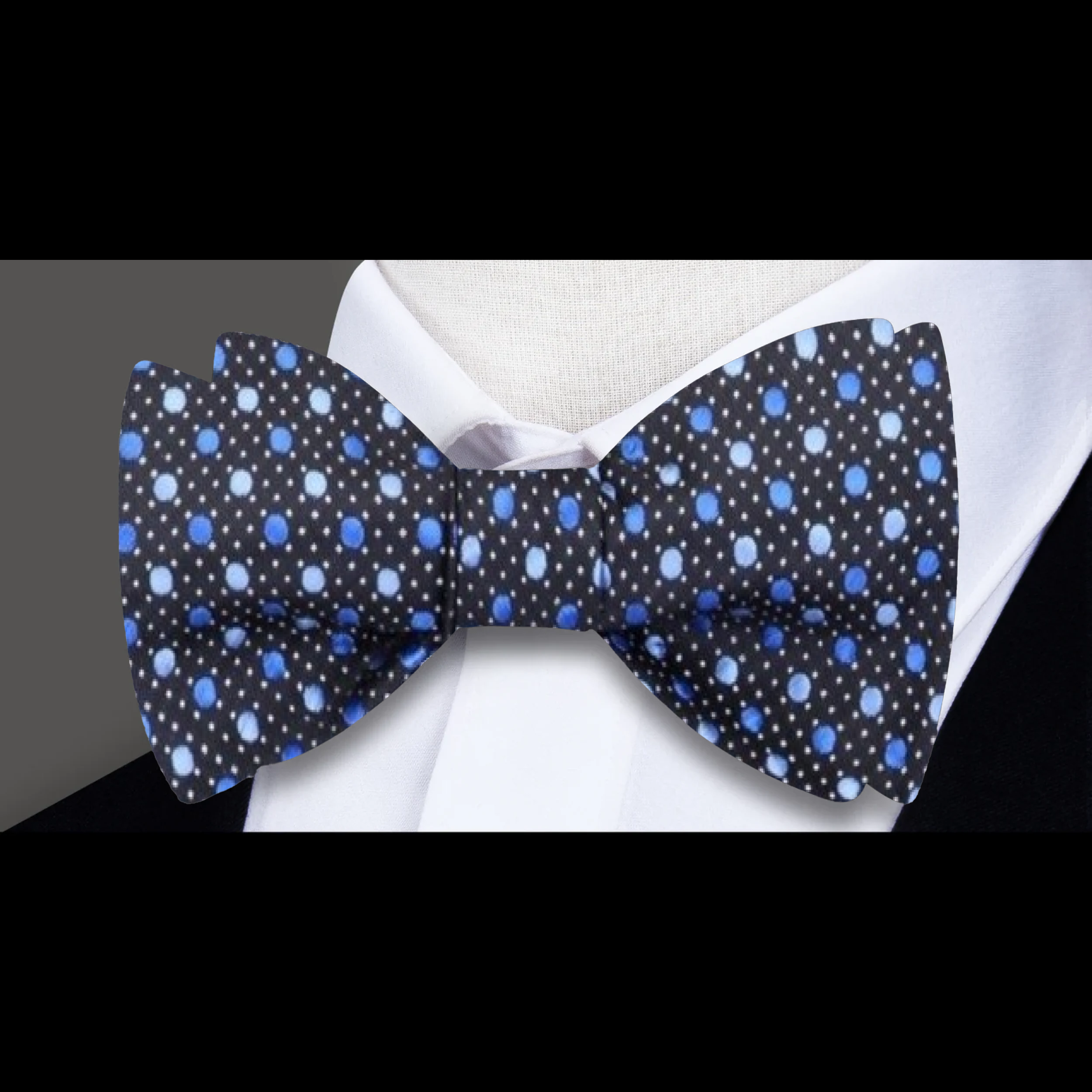 Self tie bow tie and matching pocket square laid flat, showcasing silk texture