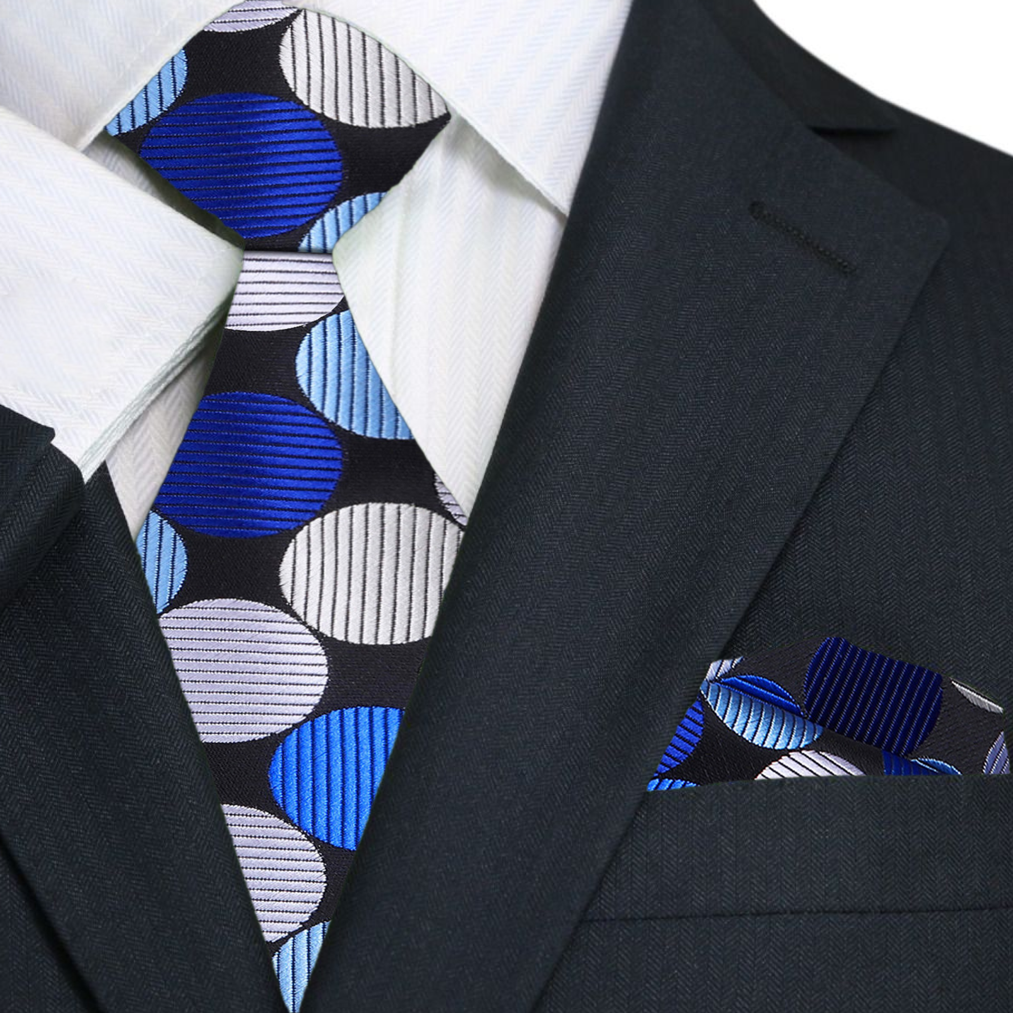 Large polka dot silk necktie in vibrant colors, showcasing the bold pattern against a white shirt.