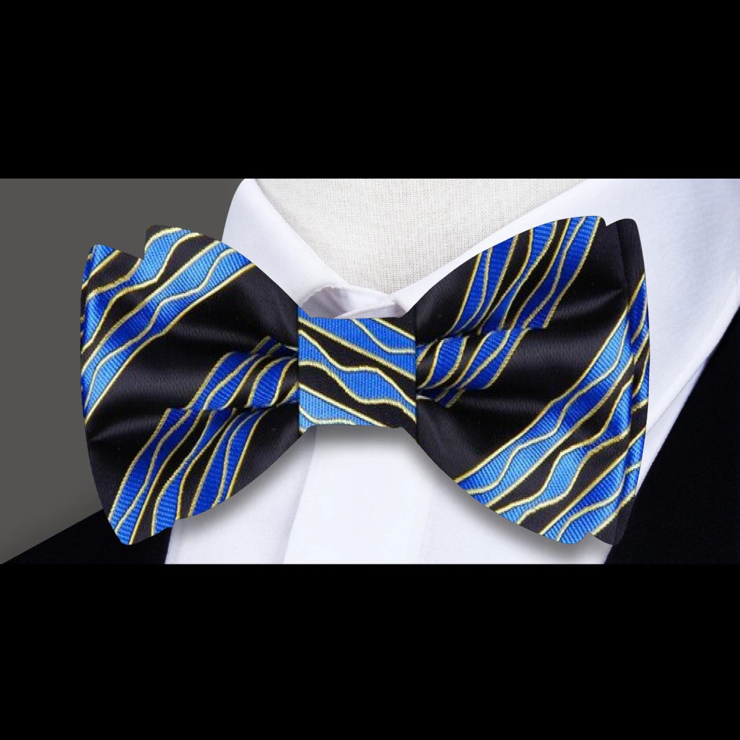 Man wearing a grey silk bow tie with a modern, sophisticated look