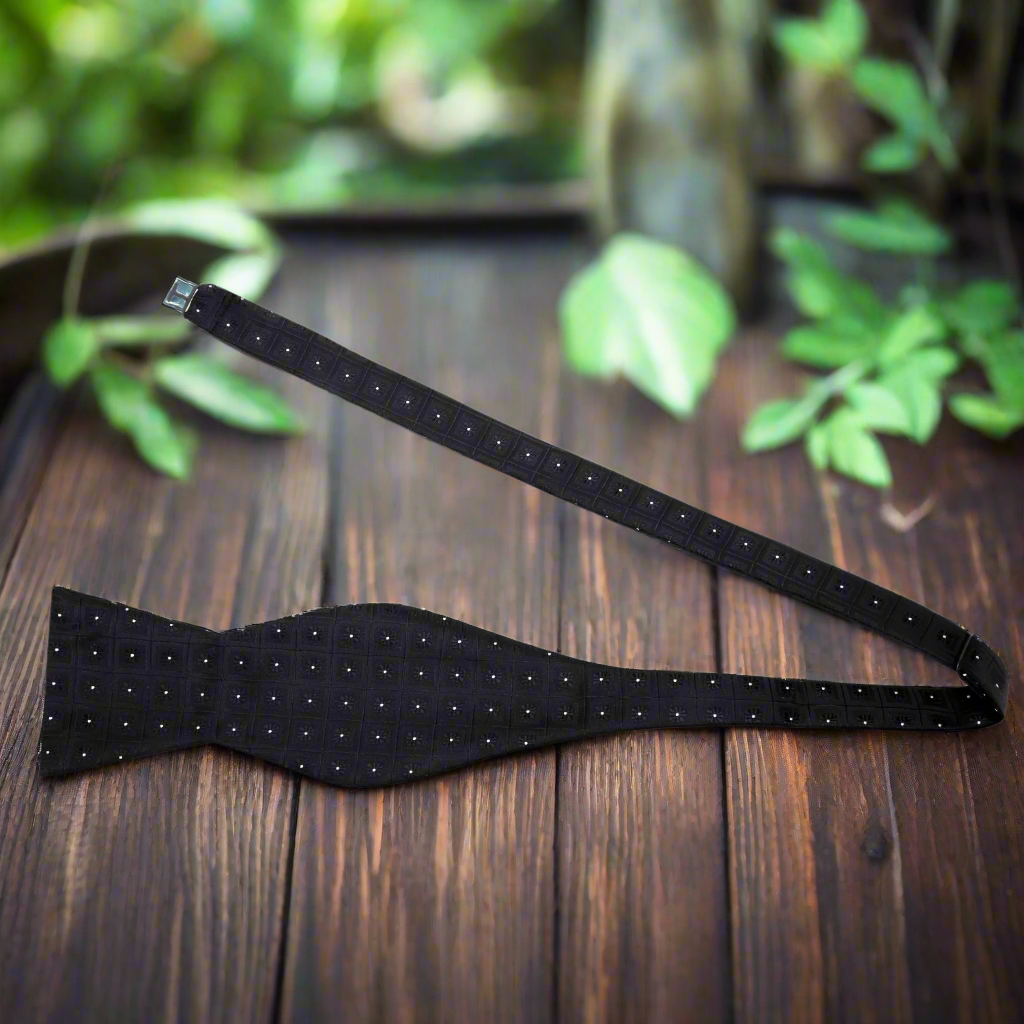 Elegant geometric patterned bow tie paired with a navy suit for a corporate event