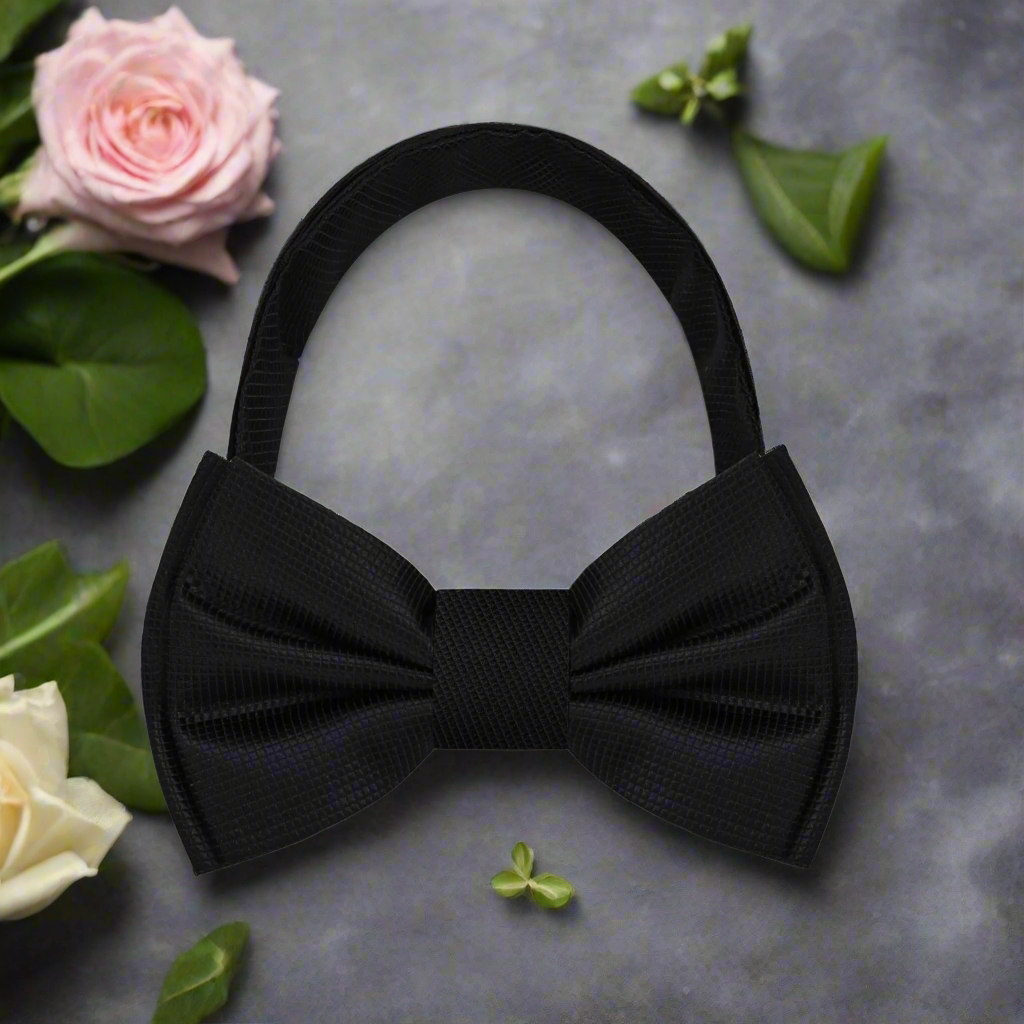 Classic Solid Black Bow Tie styled with a crisp white shirt and black tuxedo.