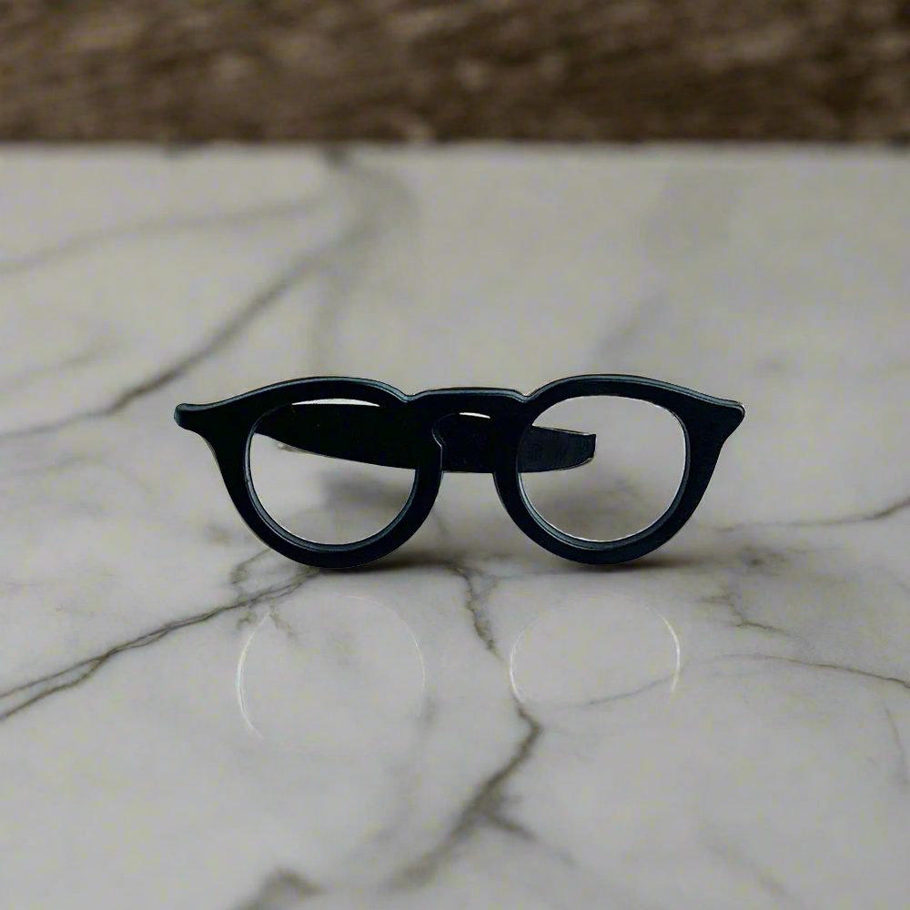 Whimsical glasses tie clip styled with a navy blue suit for a professional look