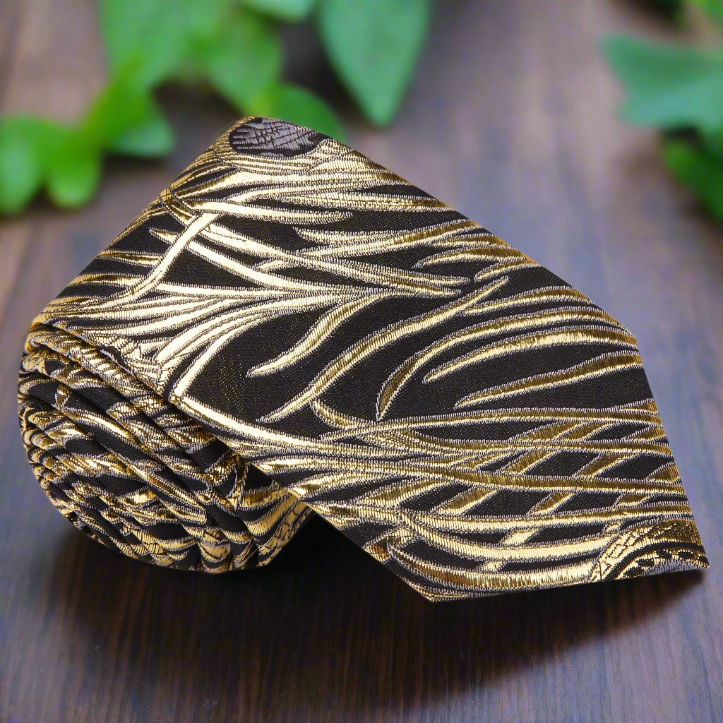 Close-up of black silk necktie with gold abstract feather pattern, perfect for formal ties collection
