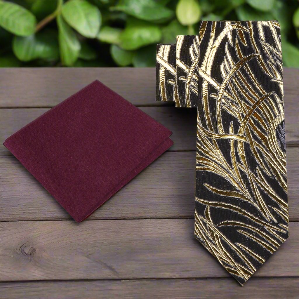 Close-up of black silk necktie with gold abstract feather pattern, perfect for formal ties collection