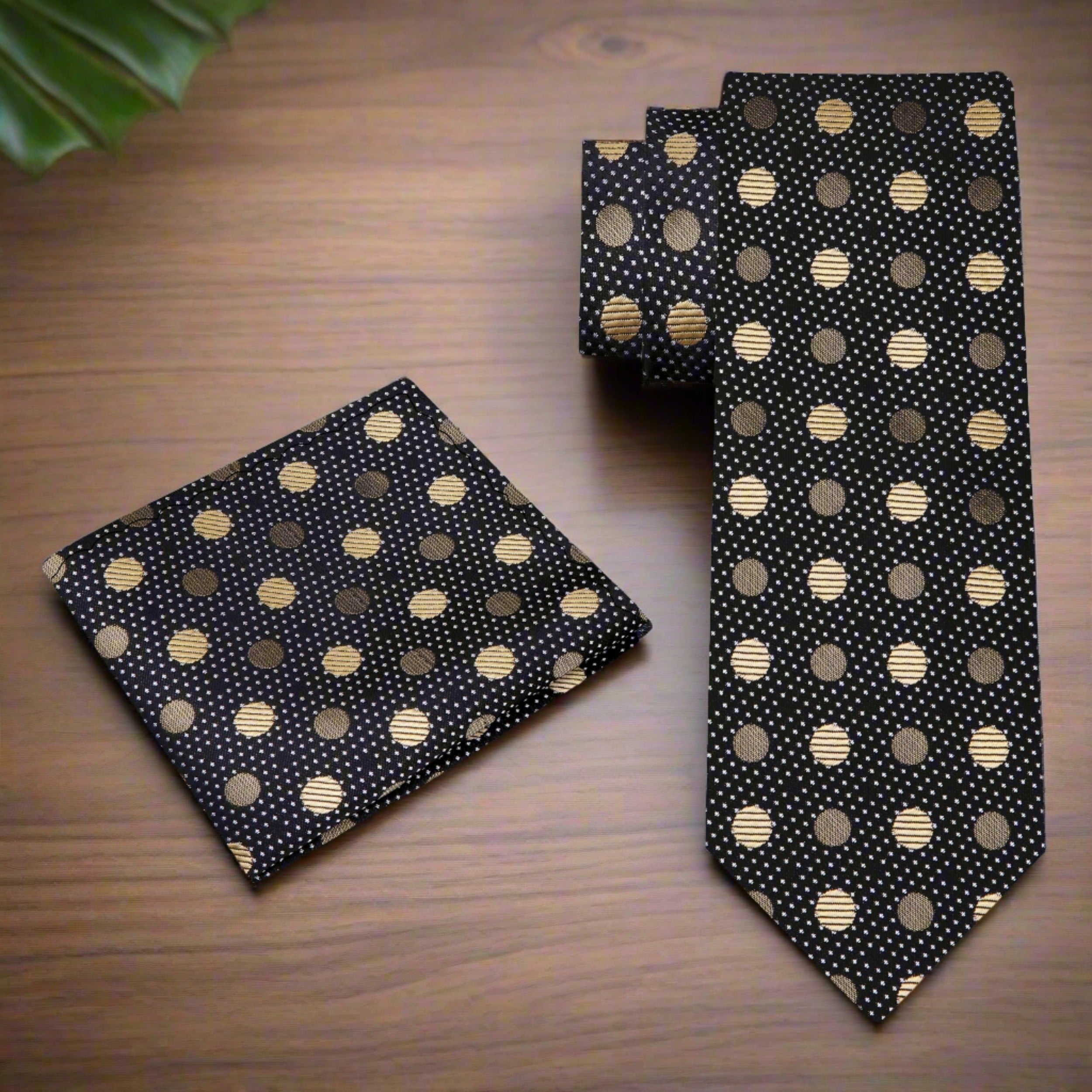 Elegant black polka dot necktie displayed on a suit, showcasing its luxurious silk texture.
