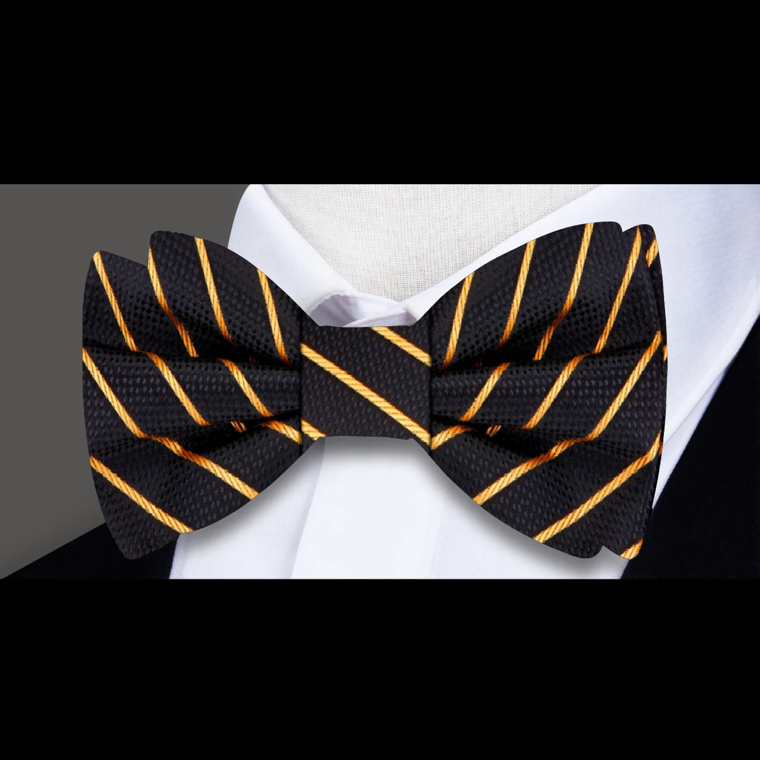 Close-up of black silk bow tie with gold pinstripes for formal wear