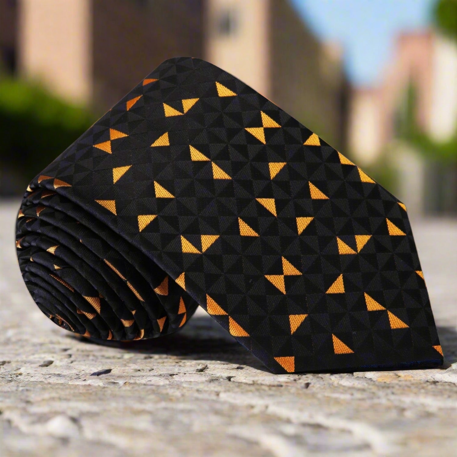 Man wearing black silk necktie with orange triangles at a wedding reception