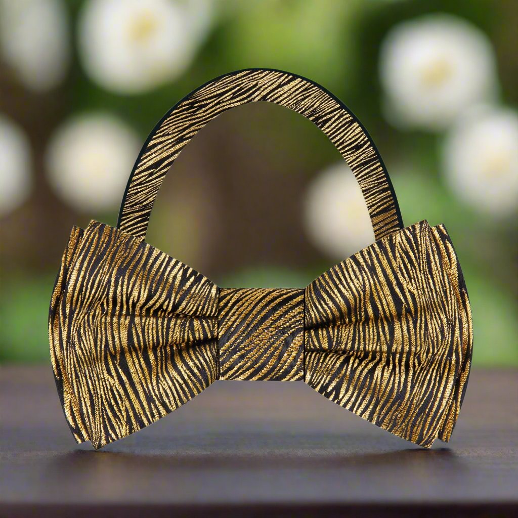 Black silk bow tie with metallic gold zebra pattern on a models neck