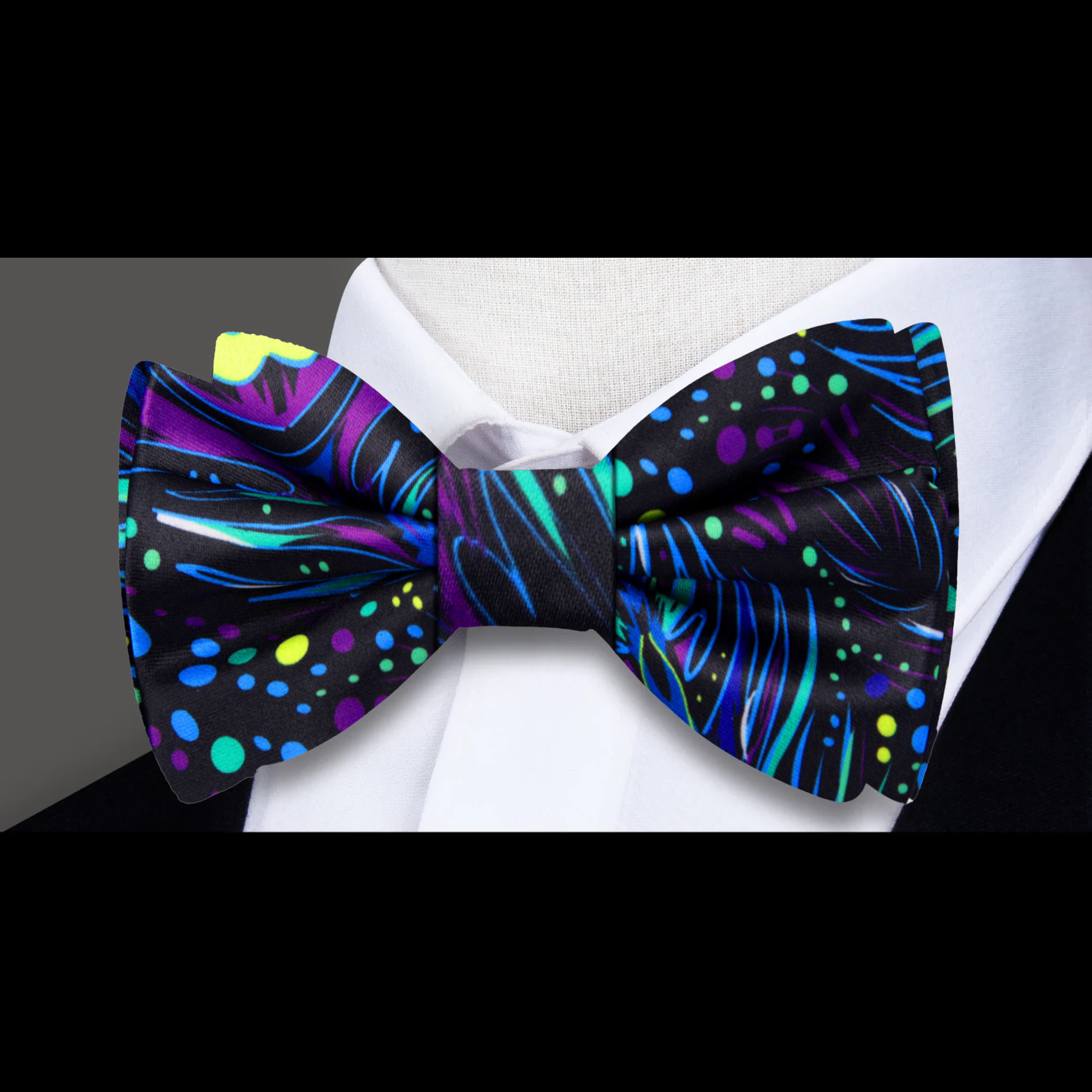 Peacock bow tie paired with a matching pocket square, styled for a formal event.