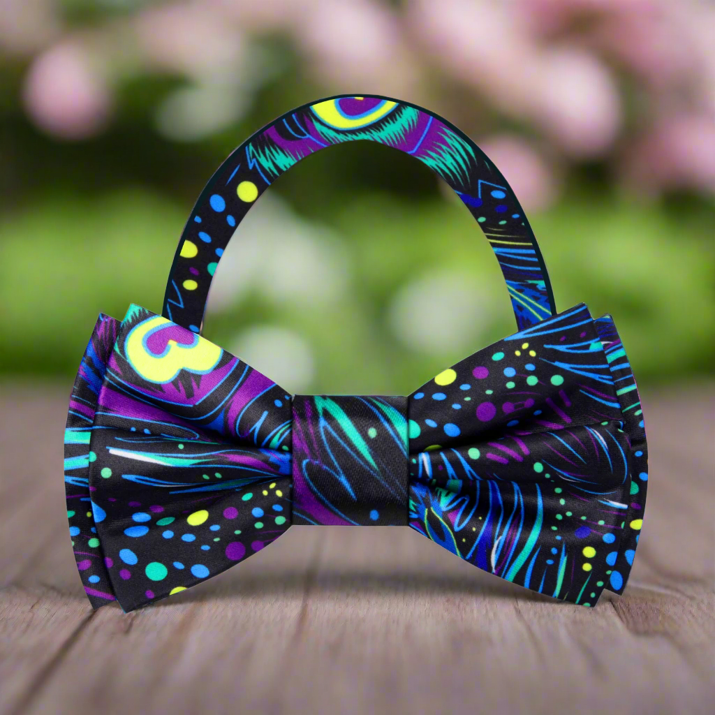 Peacock bow tie displayed on a black suit, highlighting the vibrant colors.