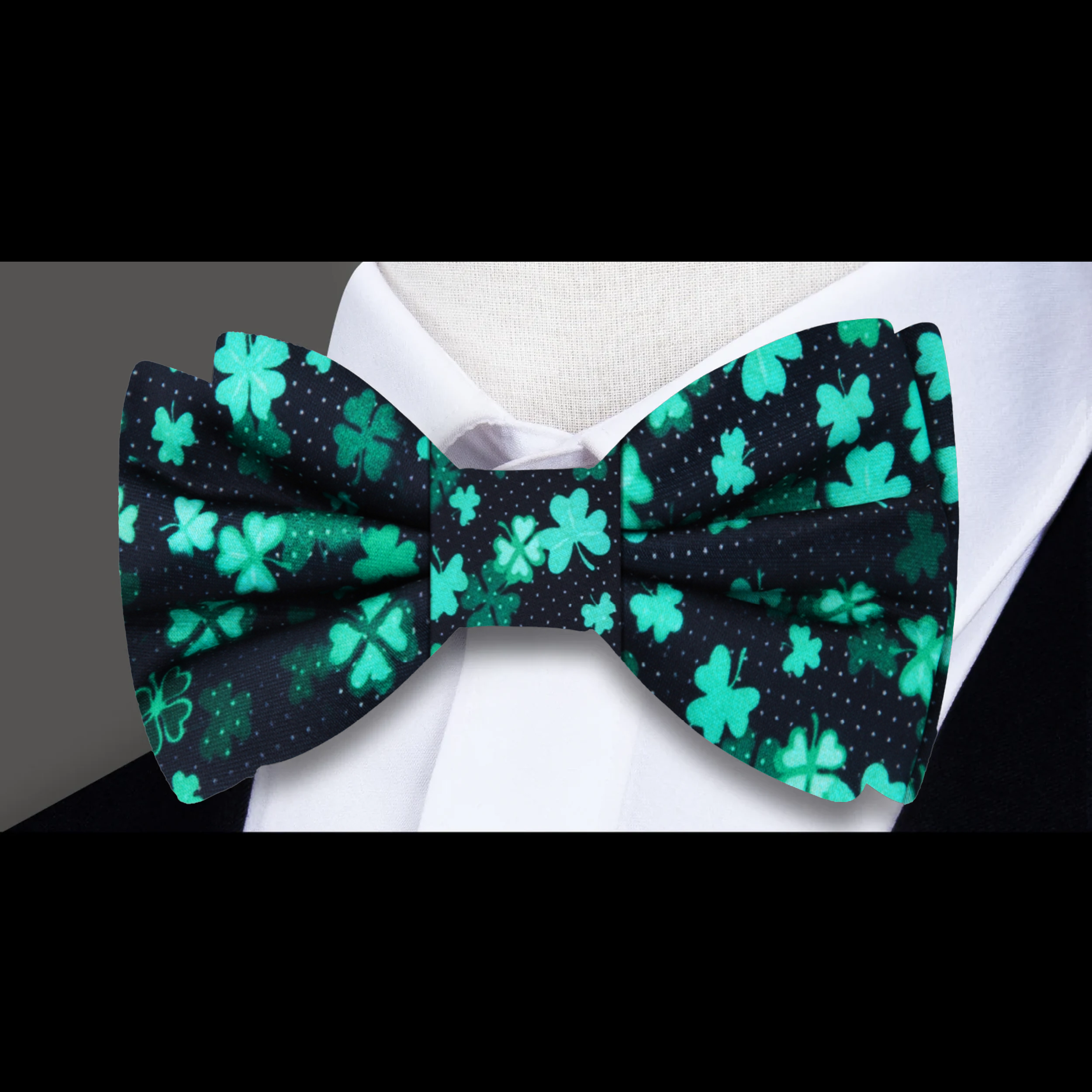 Man wearing a luxury silk bow tie with a four-leaf clover pattern at a St. Patricks Day party.