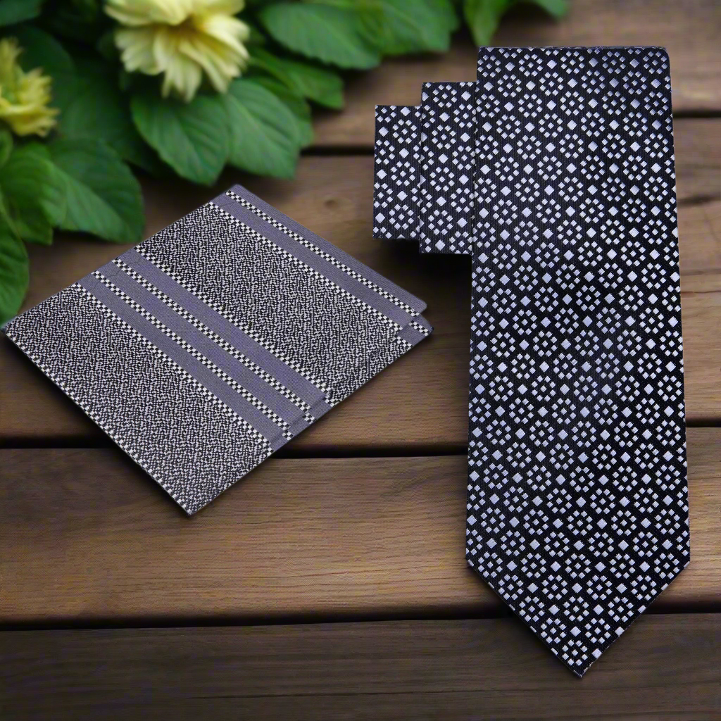 Close-up of black and grey geometric silk necktie showing pattern and texture