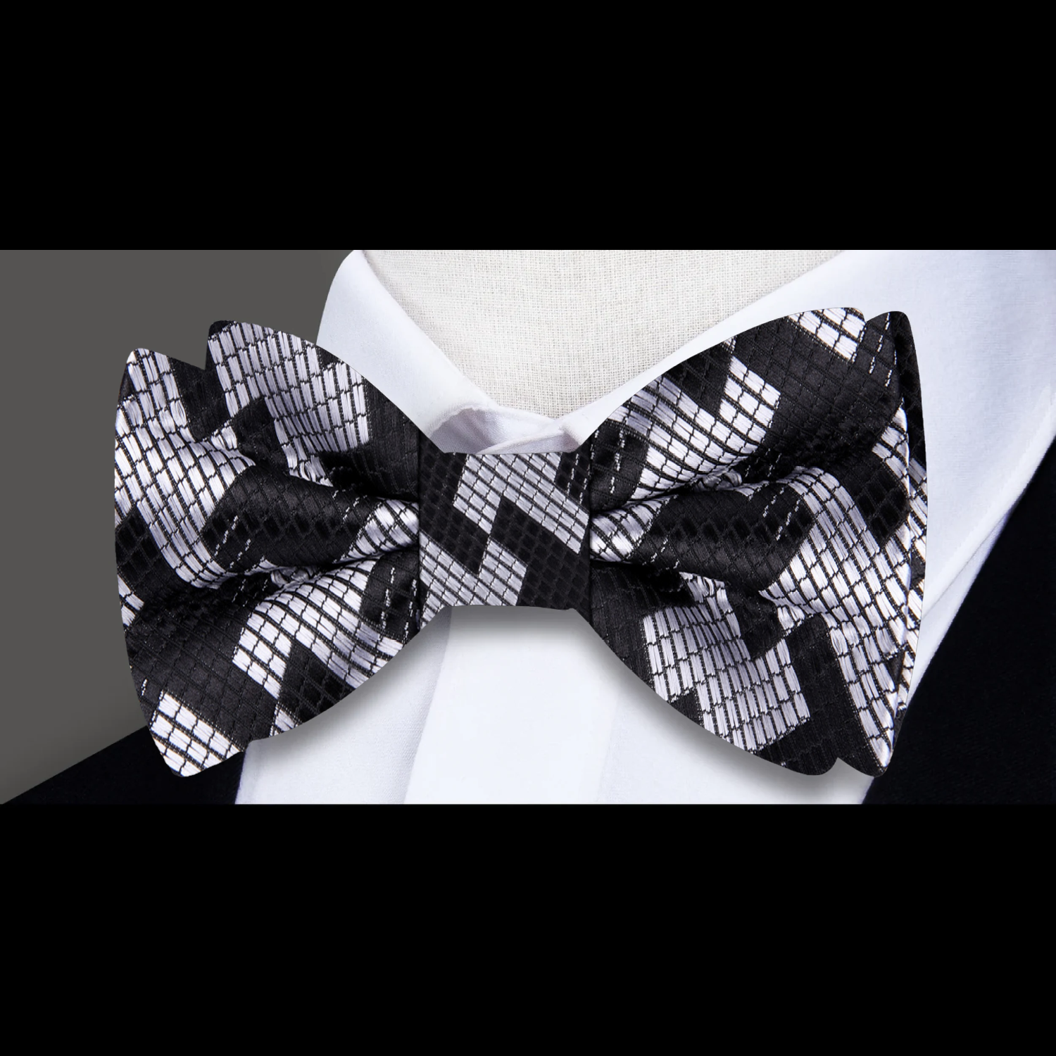 Close-up of a large houndstooth bow tie in red and silver for weddings