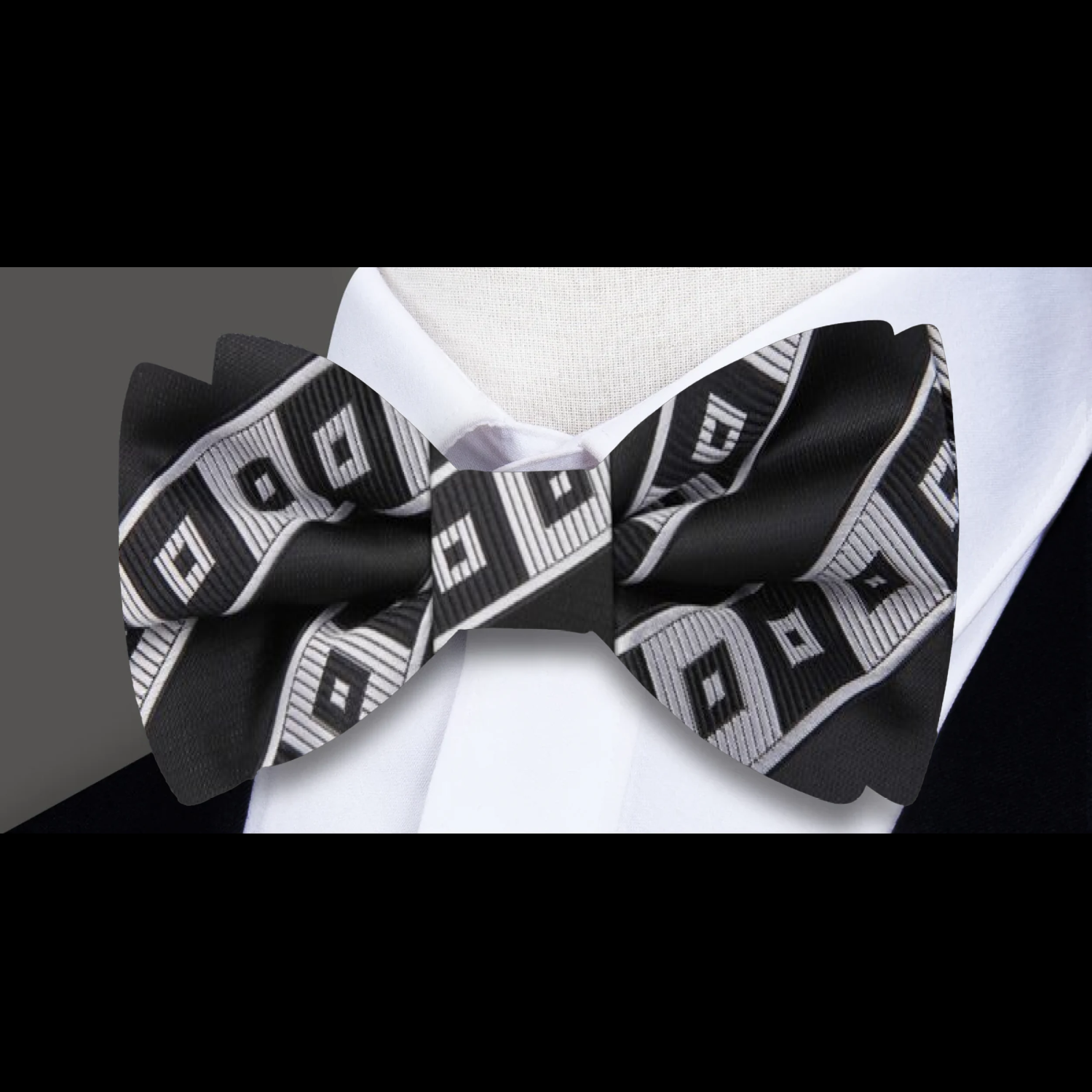 Men wearing a geometric silk bow tie at a wedding ceremony