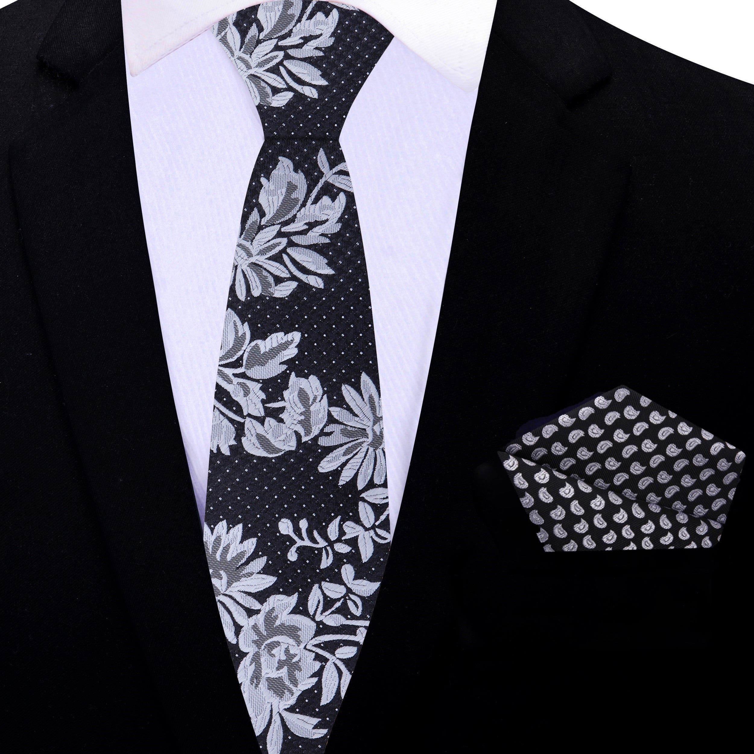 Close-up of a stylish black silk tie with floral pattern at the bottom