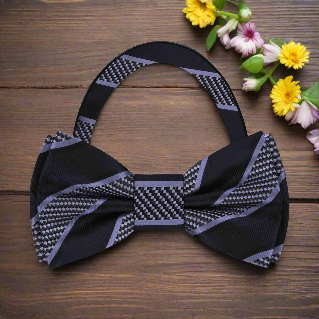 Model wearing a silk striped bow tie with a navy suit for a formal event
