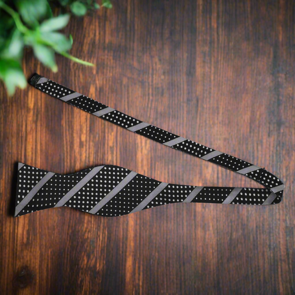 Elegant bow tie paired with a charcoal grey suit, perfect for formal events.