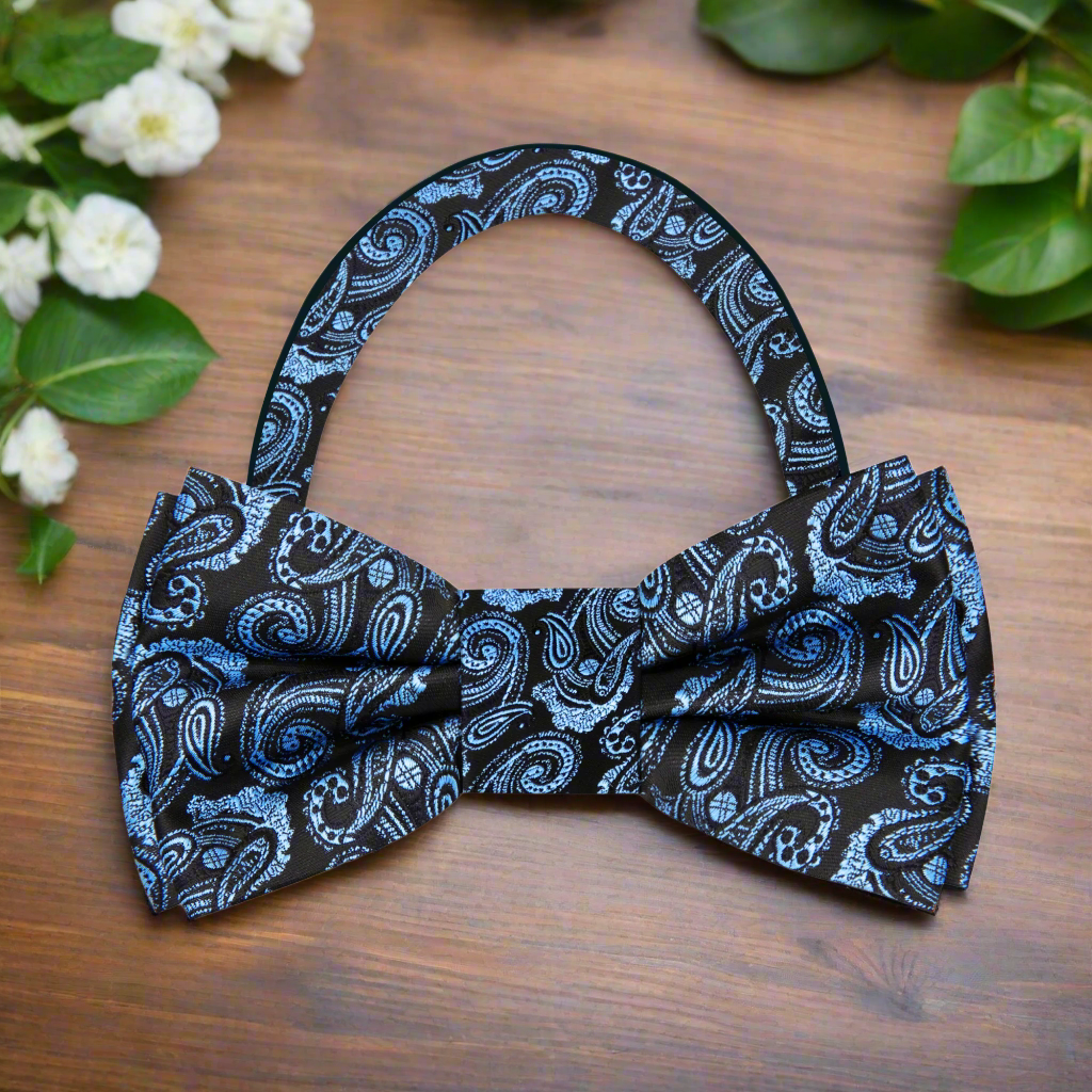 Close-up of black and ice blue paisley silk bow tie on a model