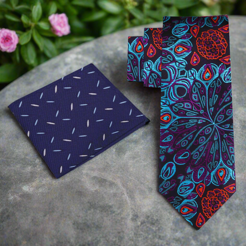 Peacock feather necktie displayed elegantly on a wooden surface with a light blue dress shirt.