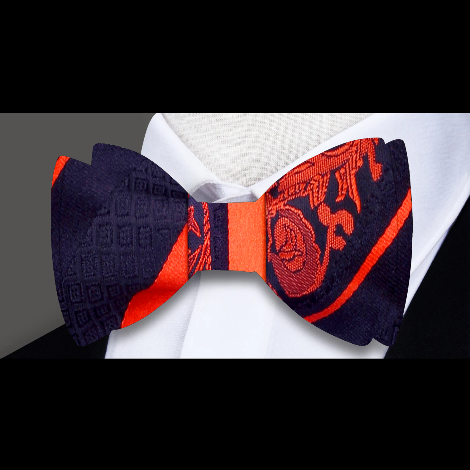 Close-up of black floral bow tie with red accents for formal wear