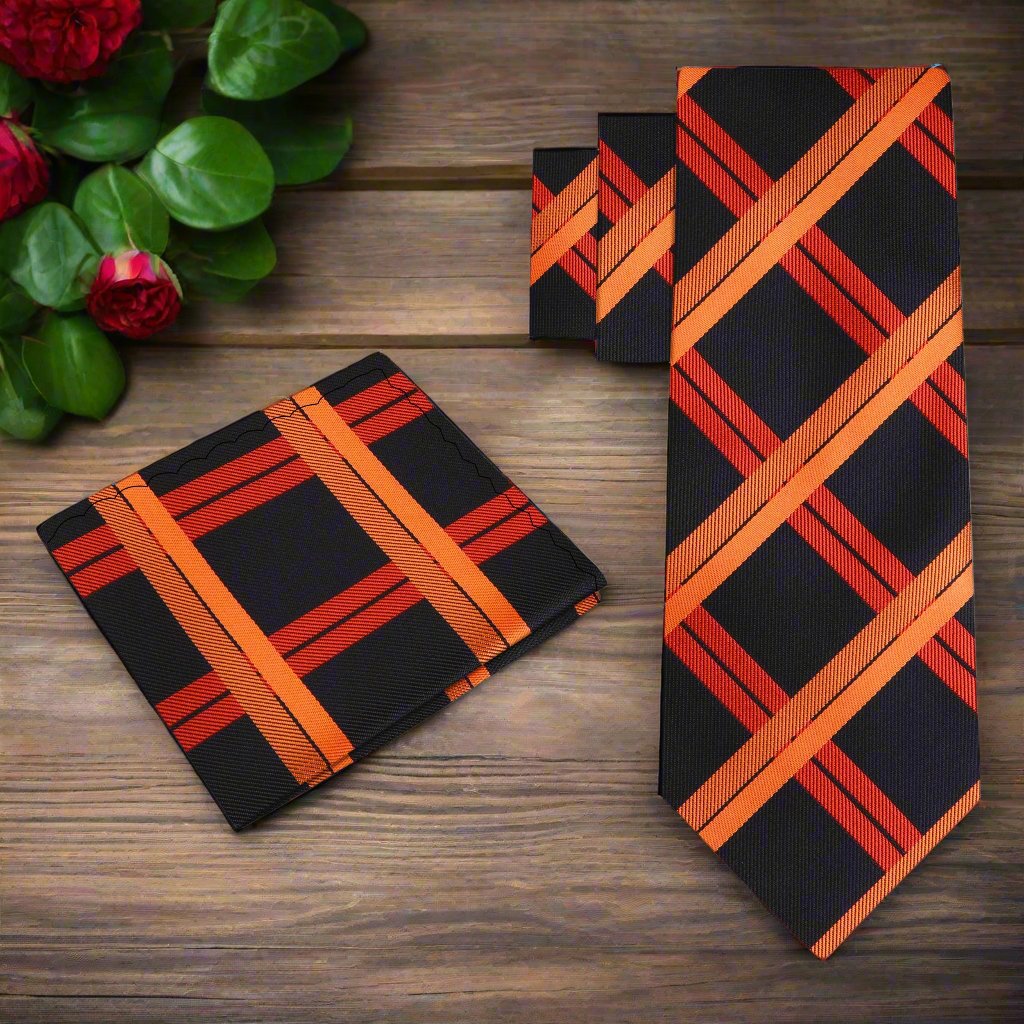 Man adjusting the black and orange silk necktie in a professional setting