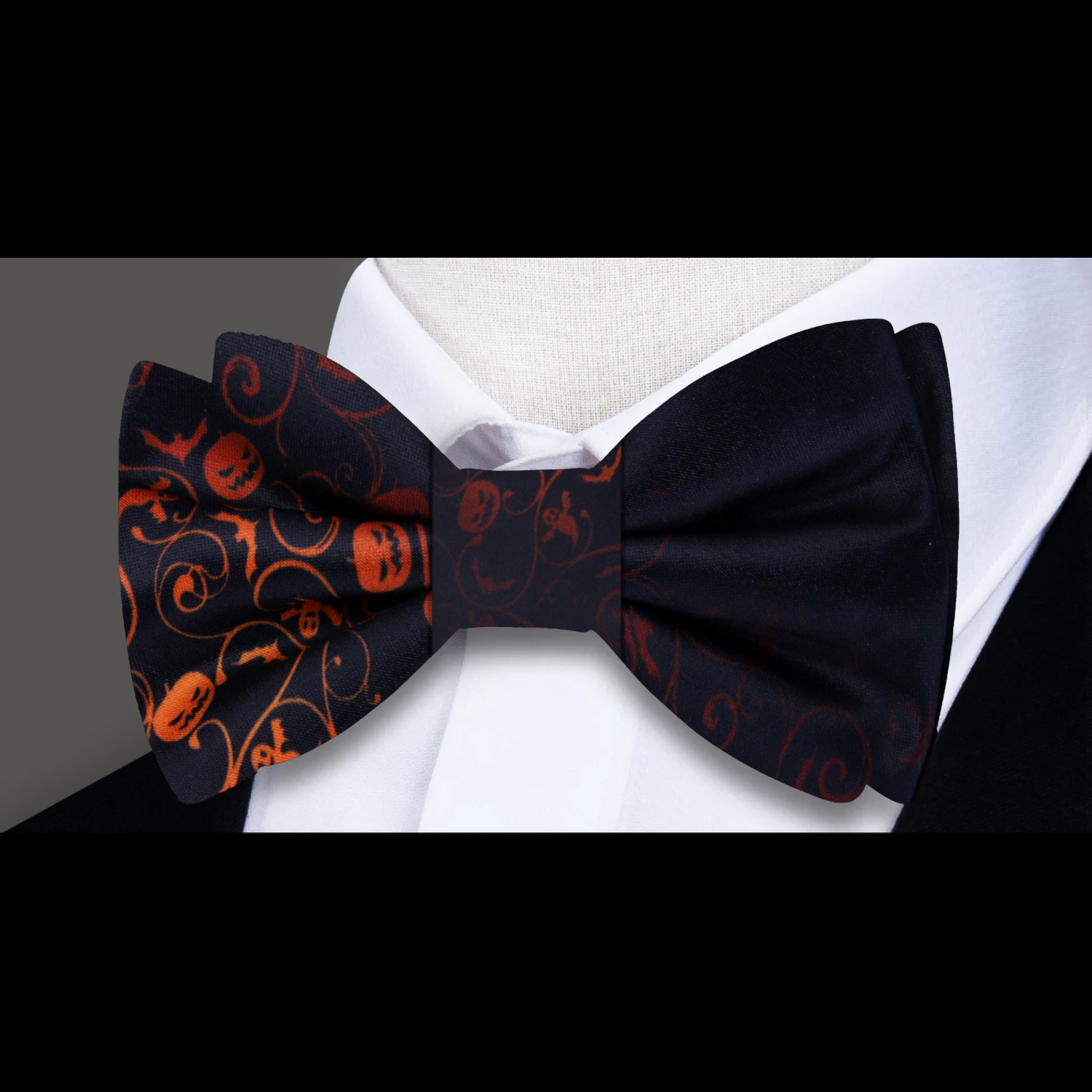 Flat lay of the Halloween bow tie alongside a matching pocket square with jack-o-lanterns, highlighting its stylish design.