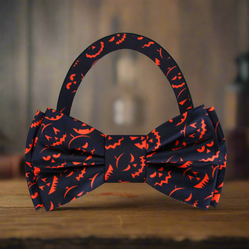 Close-up of a black and orange jack-o-lantern silk bow tie for Halloween