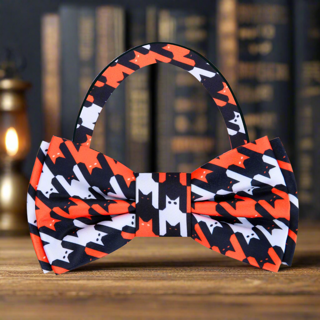 Close-up of a Halloween Cats silk bow tie with bats and cats pattern in vibrant colors