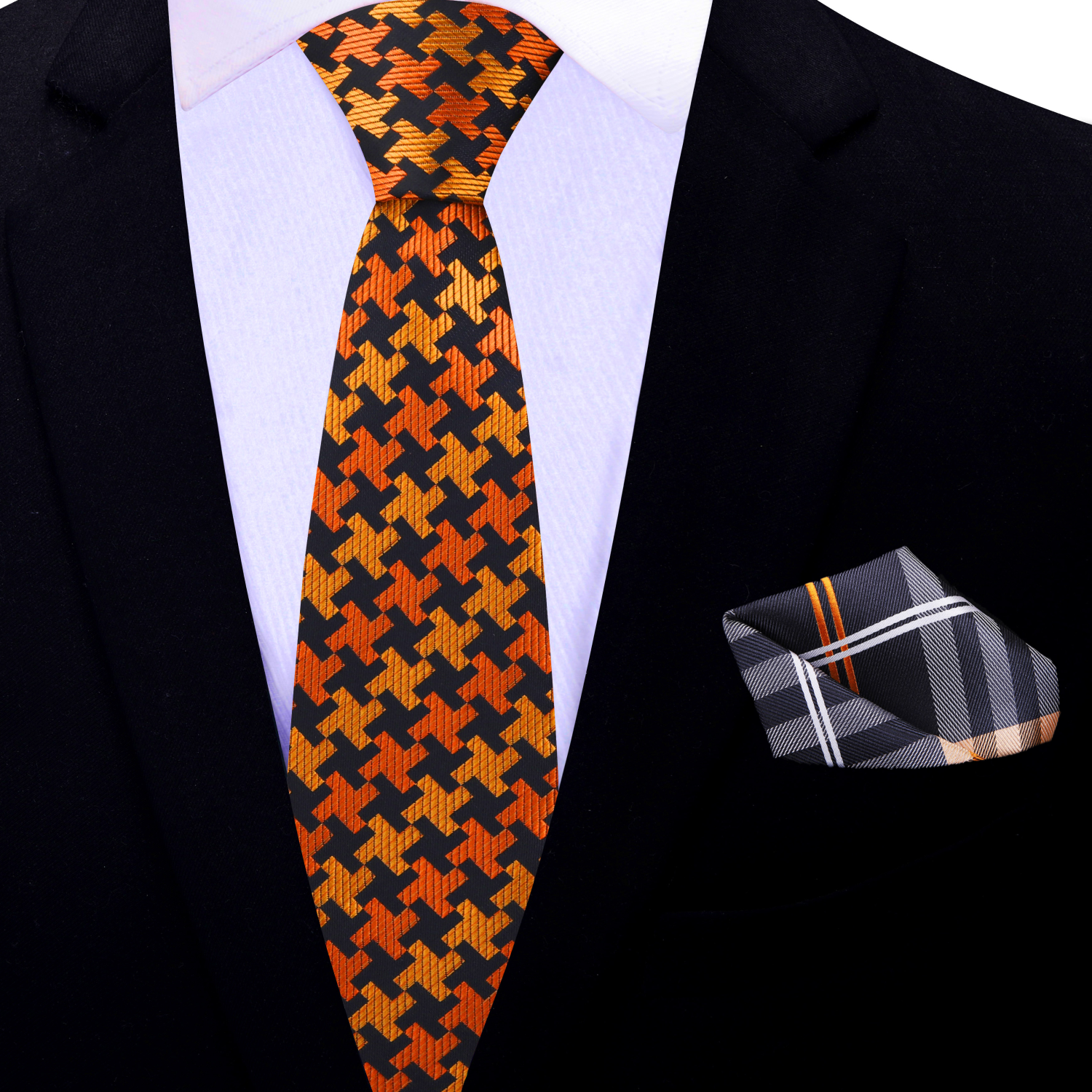 Close-up of houndstooth tie in orange, black, and yellow laid across a charcoal grey suit