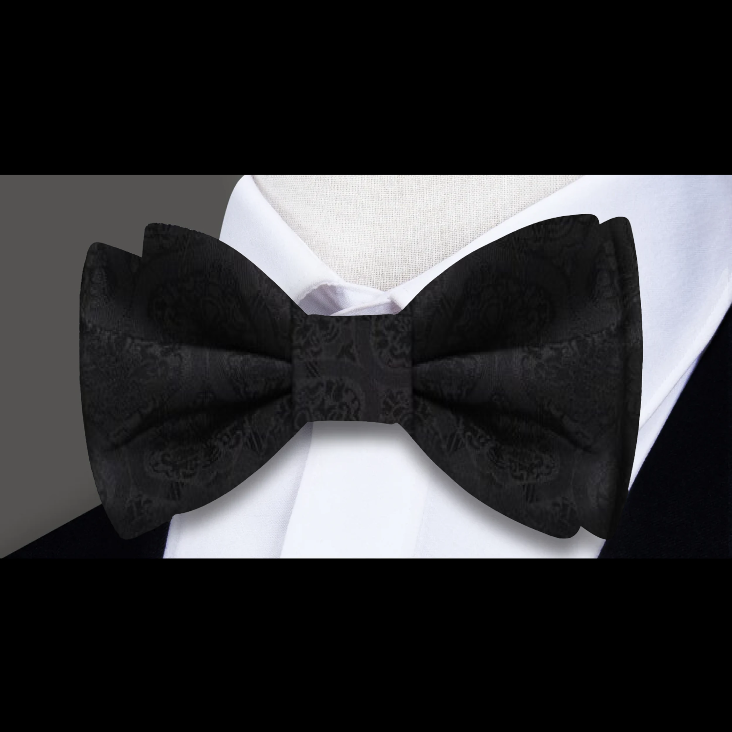 Model wearing the abstract silk bow tie at a wedding, styled with a crisp white dress shirt.