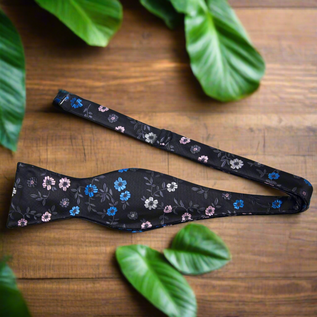 Self-tie floral bow tie paired with a pocket square, showcasing sophisticated style.
