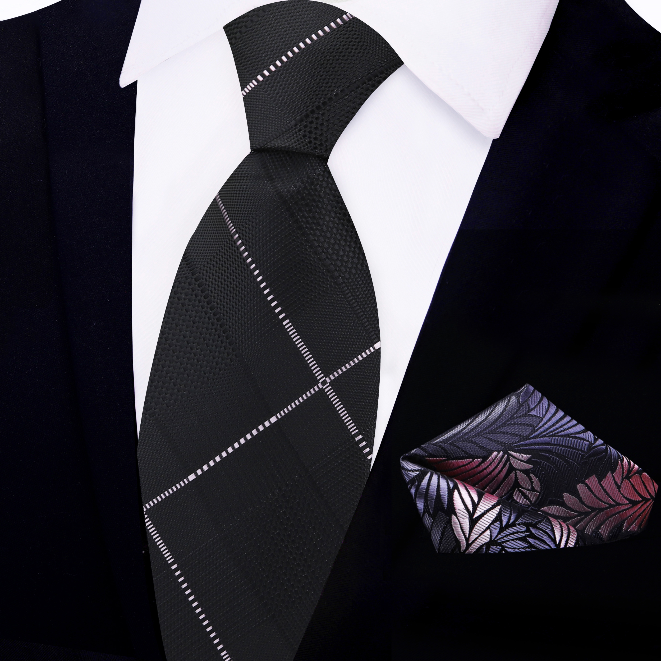 The stylish black plaid necktie displayed with a white dress shirt.