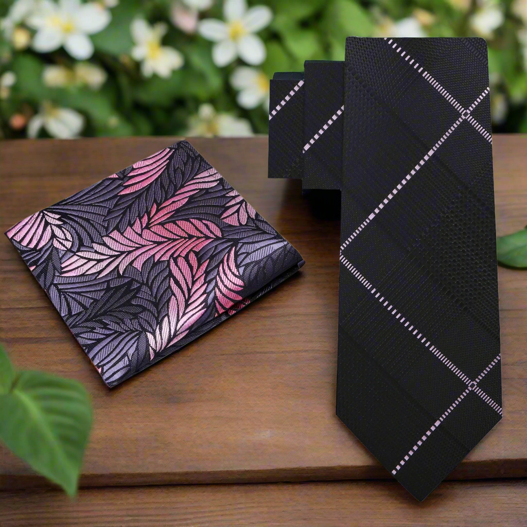 The stylish black plaid necktie displayed with a white dress shirt.