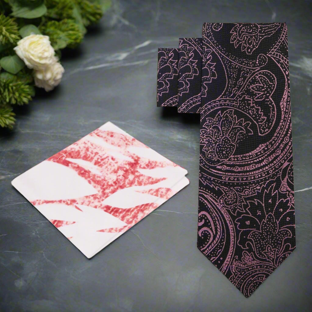 Close-up of the elegant rose gold paisley necktie against a dark background, showcasing its intricate design.
