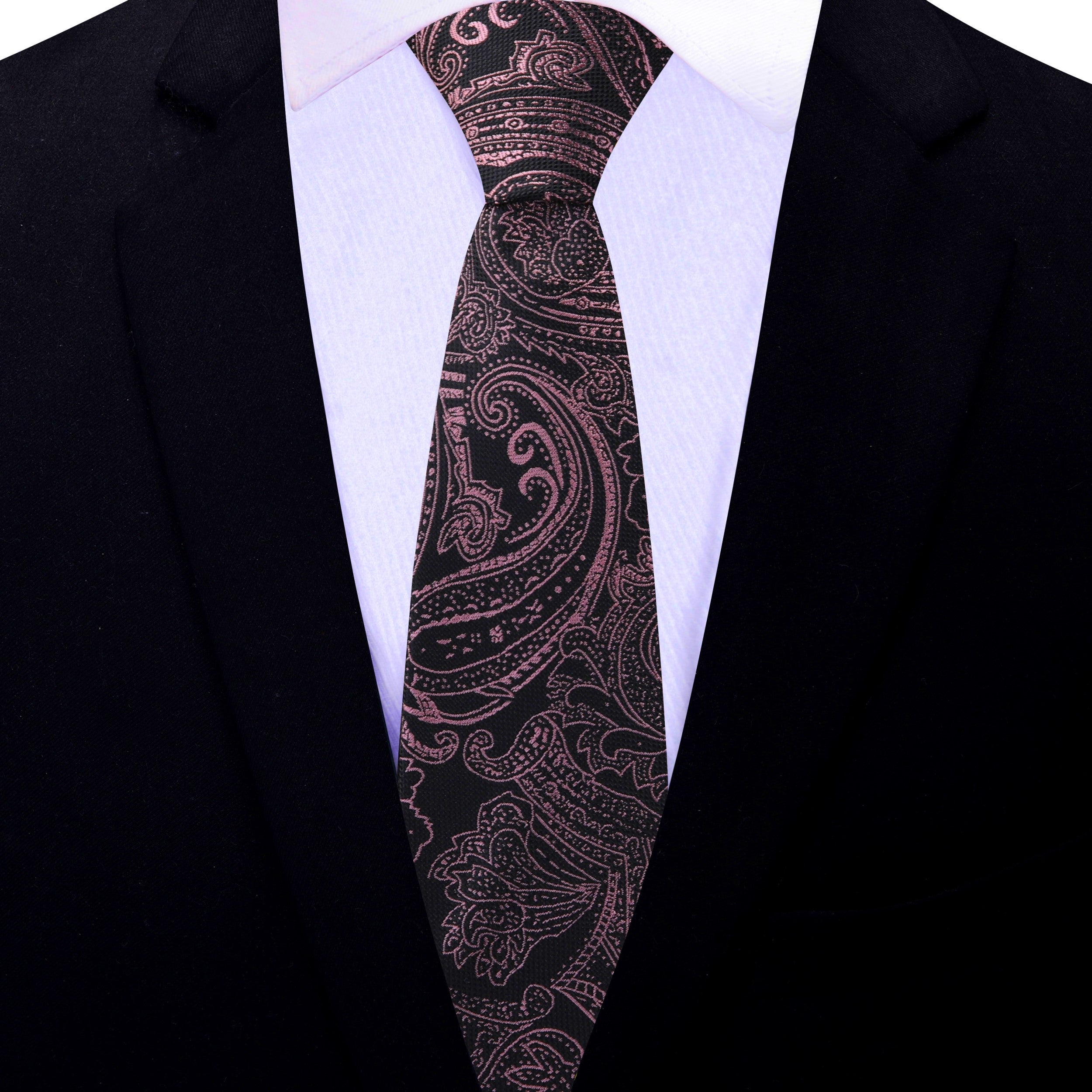Black necktie with rose gold paisley pattern displayed alongside a white dress shirt for a classic look.