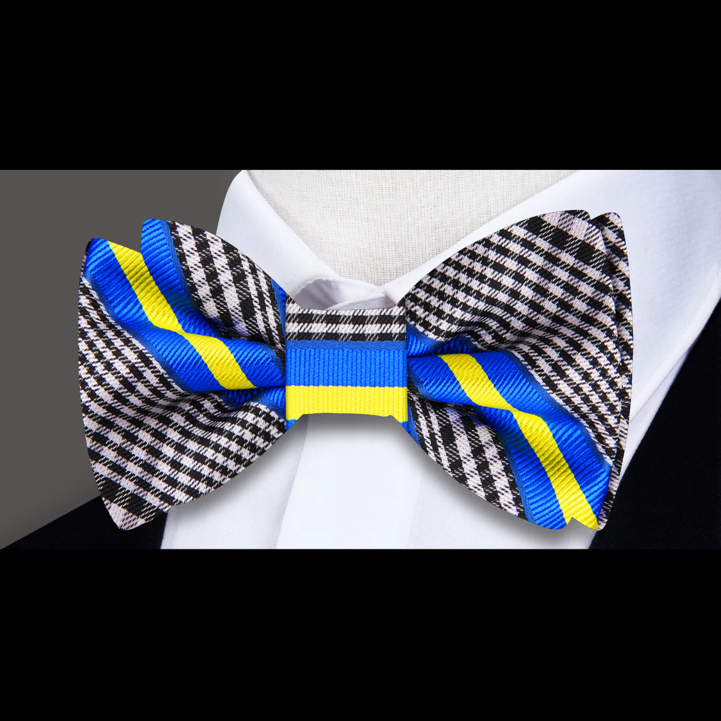 Man wearing a silk plaid bow tie at a wedding ceremony