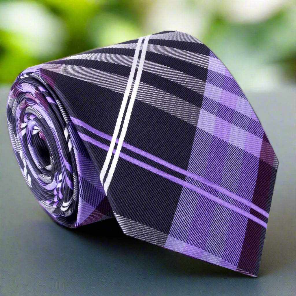 Close-up view of Norhaven plaid silk necktie showcasing the detailed pattern in dark grey, black, and purple
